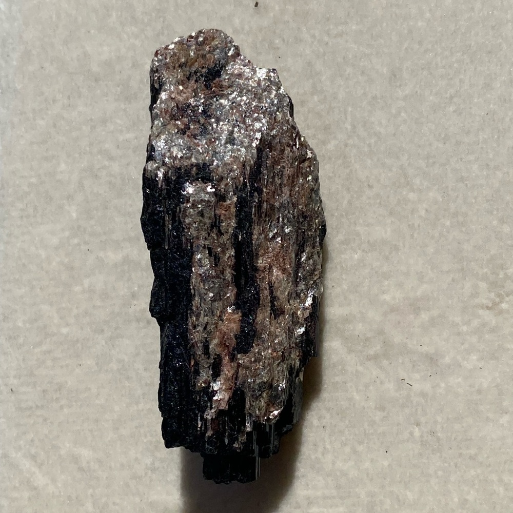 Raw Black tourmaline crystal in feldspar